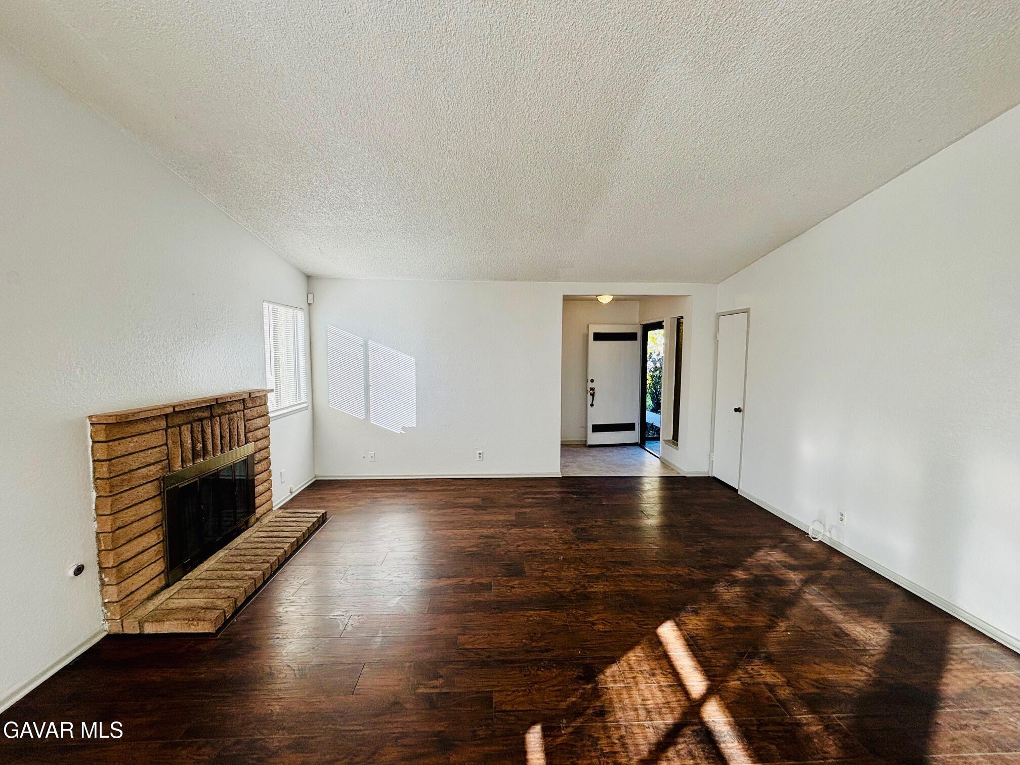 2308 Edam Street Lancaster, CA 93536 - Photo 3 of 16 a view of an empty room with wooden floor and a window