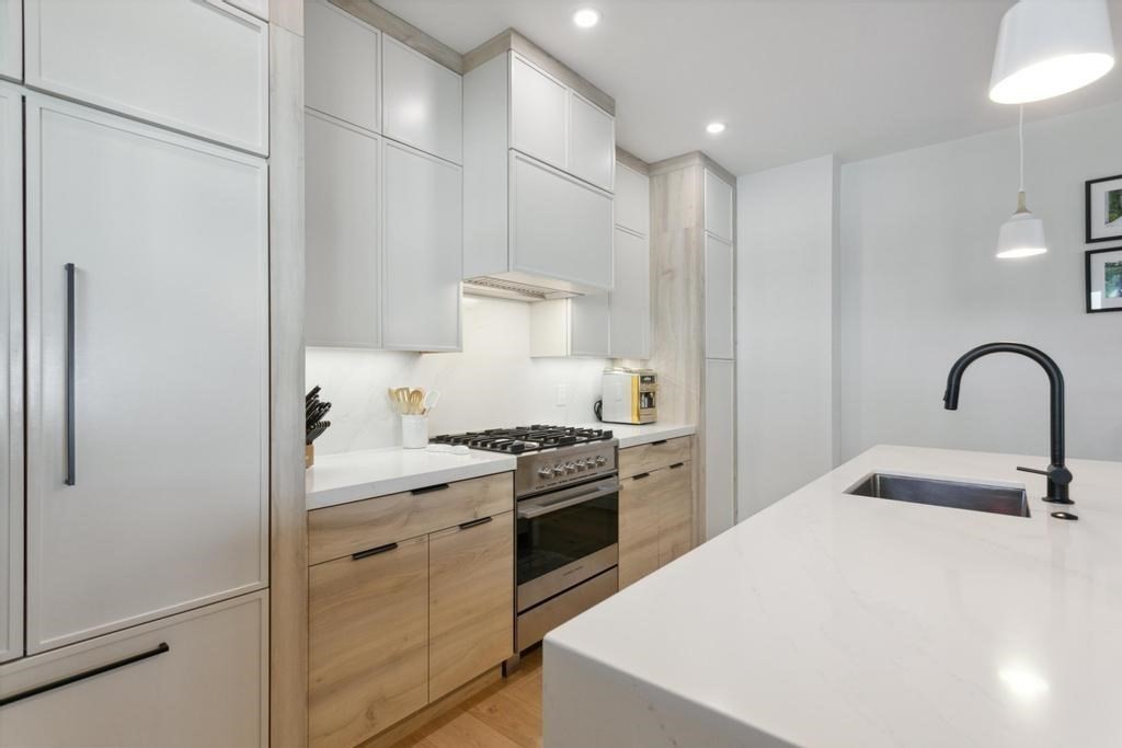 4 Payne Street, Unit 2 Boston, MA 02122 - Photo 11 of 28 a kitchen with a sink stainless steel appliances and cabinets