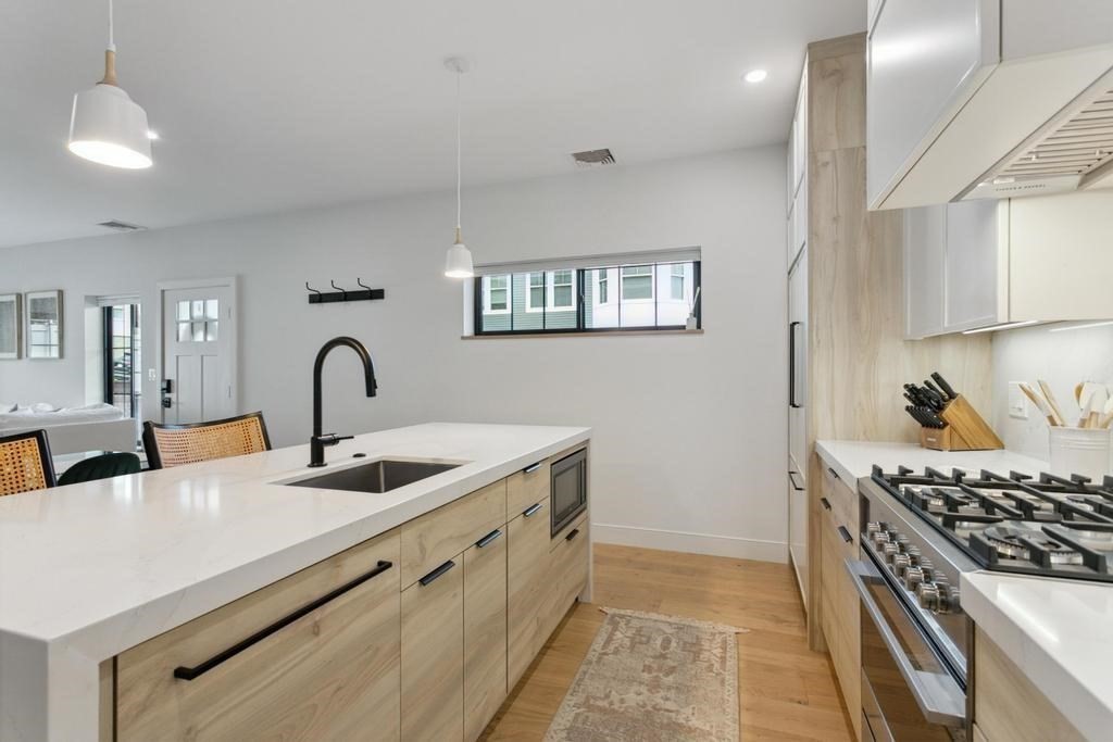 4 Payne Street, Unit 2 Boston, MA 02122 - Photo 12 of 28 a kitchen that has a sink and a stove