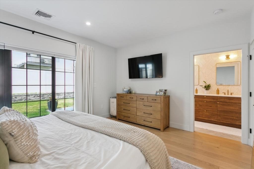 4 Payne Street, Unit 2 Boston, MA 02122 - Photo 15 of 28 a bedroom with a bed and a flat screen tv