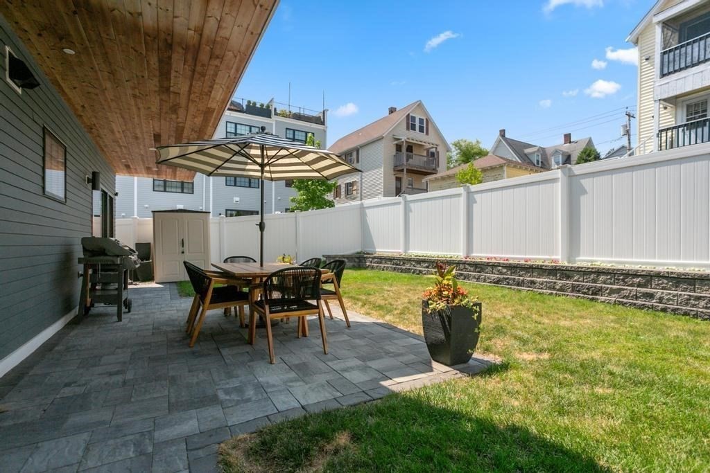 4 Payne Street, Unit 2 Boston, MA 02122 - Photo 20 of 28 a view of a swimming pool with a table and chairs