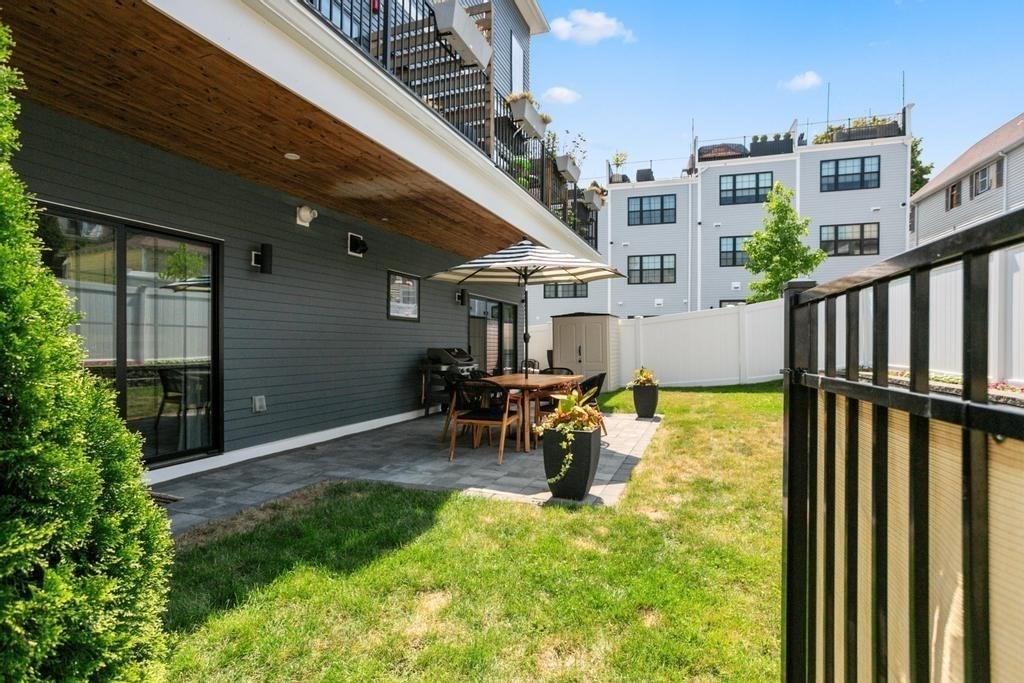 4 Payne Street, Unit 2 Boston, MA 02122 - Photo 22 of 28 a view of swimming pool with outdoor seating and a lots of flower plants in front of house