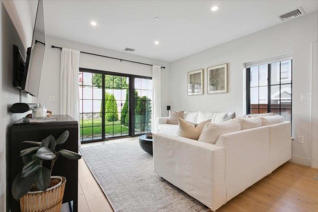4 Payne Street, Unit 2 Boston, MA 02122 - Photo 6 of 28 a living room with furniture tv and a large window