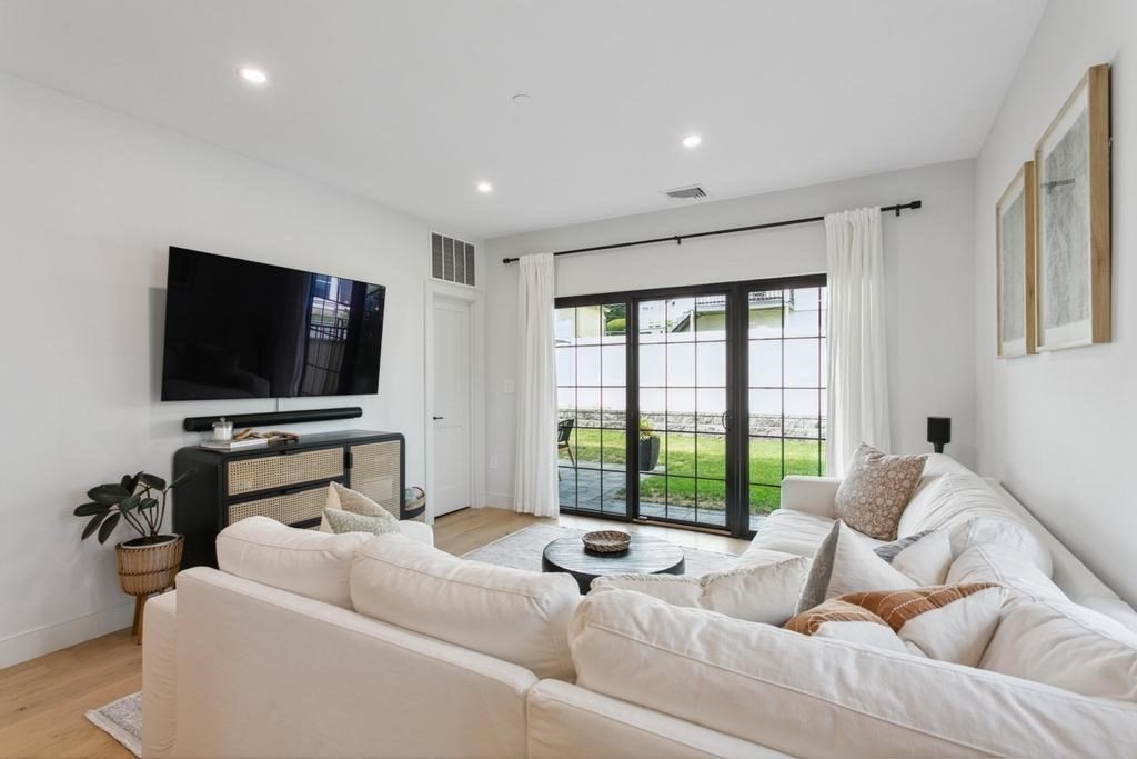 4 Payne Street, Unit 2 Boston, MA 02122 - Photo 7 of 28 a living room with furniture and a flat screen tv
