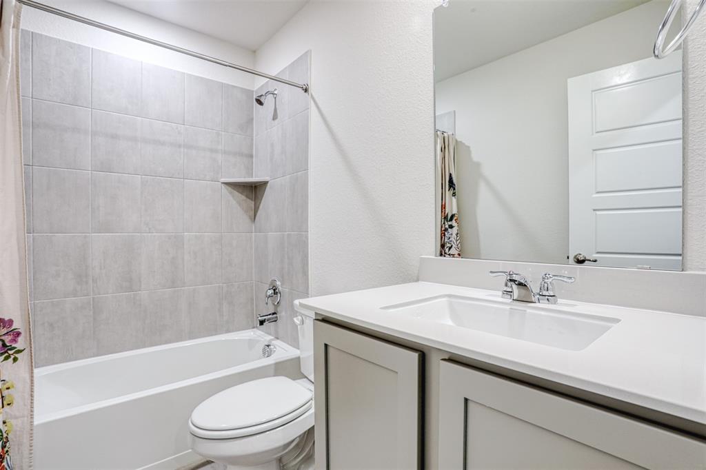 9813 Daisy Mae Aubrey, TX 76227 - Photo 12 of 28 a bathroom with a sink a toilet and a bathtub