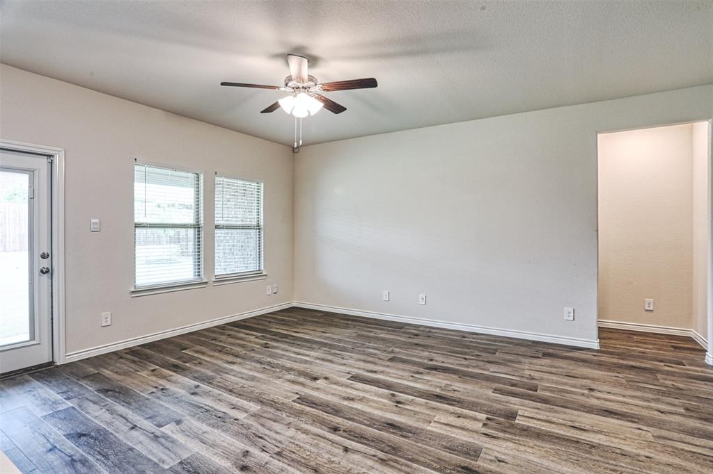 9813 Daisy Mae Aubrey, TX 76227 - Photo 14 of 28 a view of empty room with wooden floor and fan