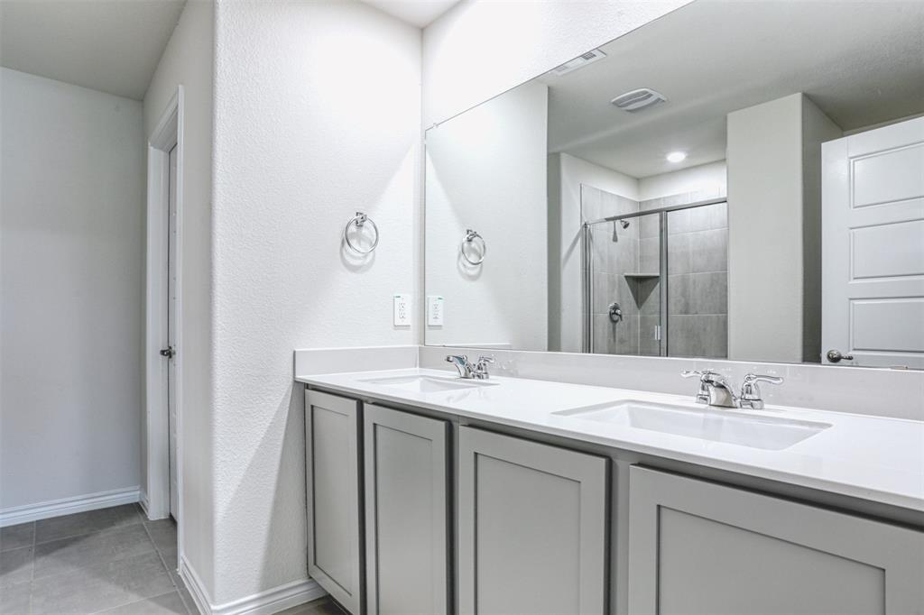 9813 Daisy Mae Aubrey, TX 76227 - Photo 19 of 28 a bathroom with a sink and a mirror