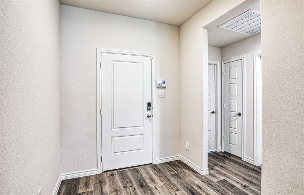9813 Daisy Mae Aubrey, TX 76227 - Photo 2 of 28 a view of a bedroom with wooden floor and closet