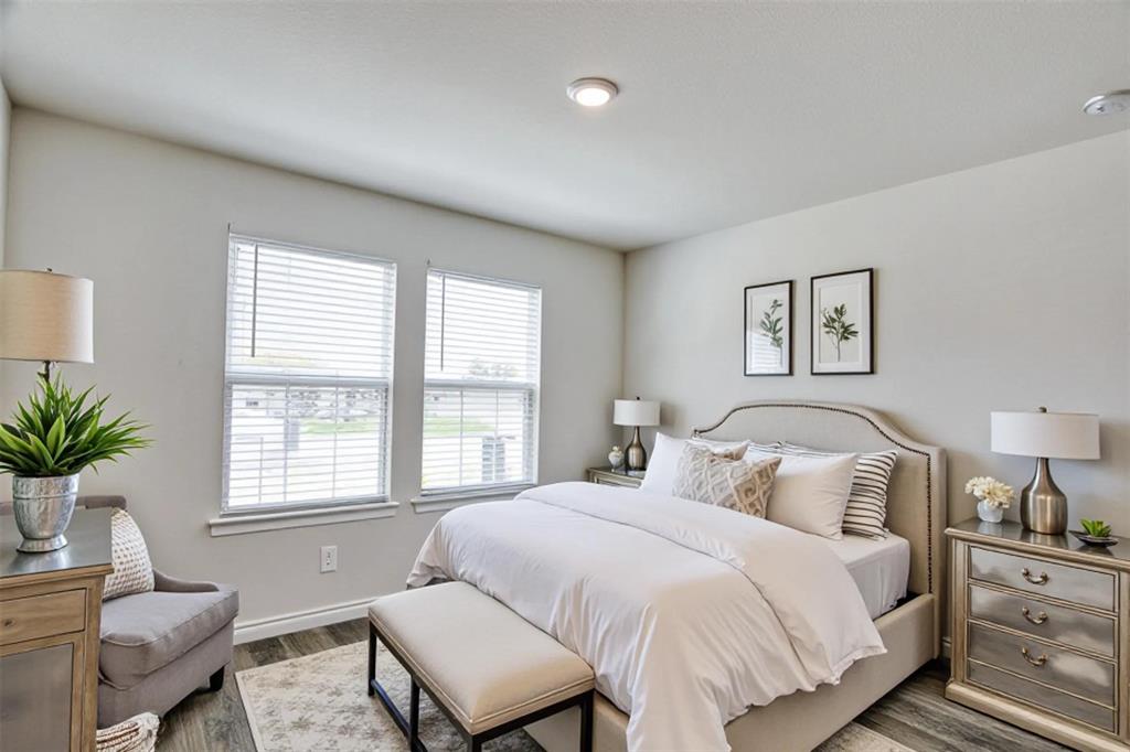 9813 Daisy Mae Aubrey, TX 76227 - Photo 21 of 28 a bedroom with a large bed and windows