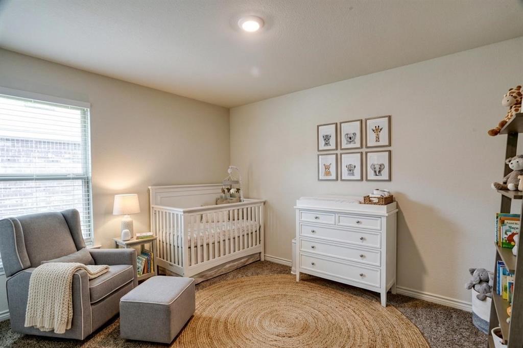 9813 Daisy Mae Aubrey, TX 76227 - Photo 25 of 28 a bedroom with furniture and a window