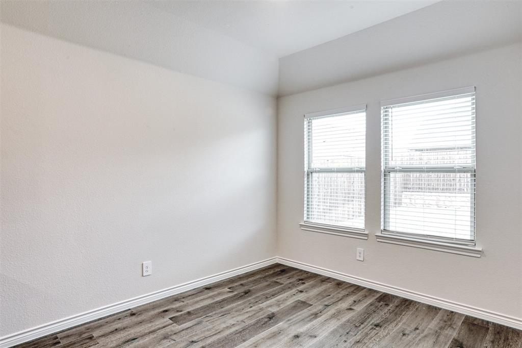 9813 Daisy Mae Aubrey, TX 76227 - Photo 8 of 28 an empty room with wooden floor and windows