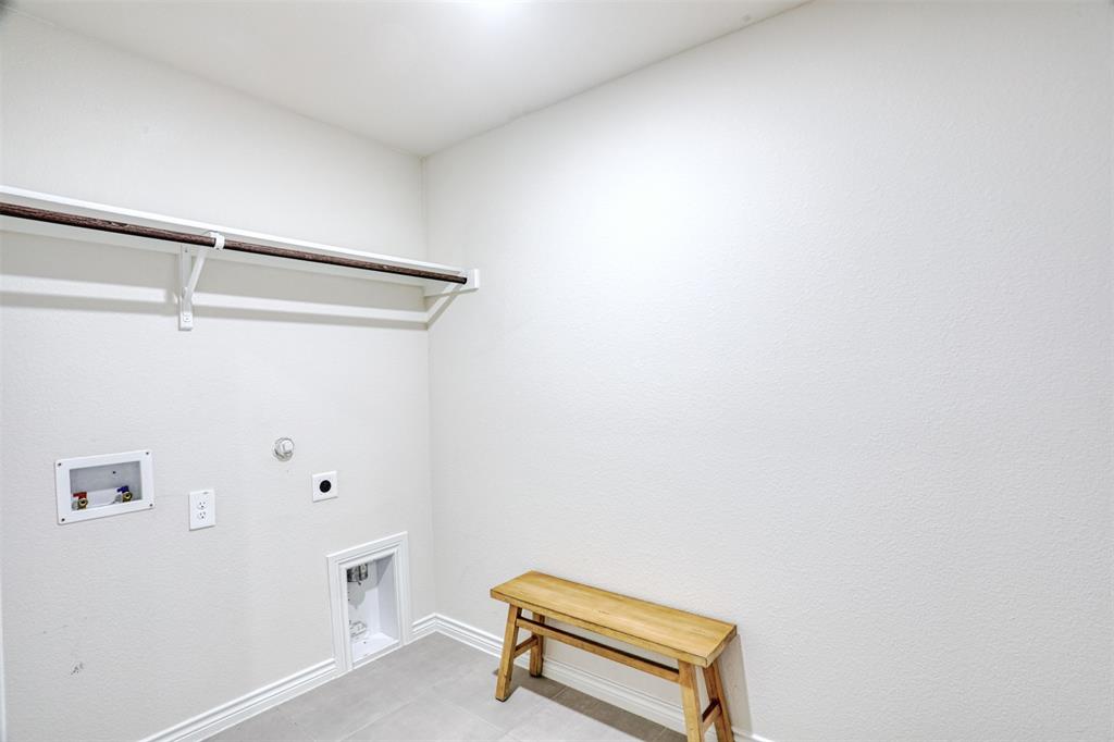 9813 Daisy Mae Aubrey, TX 76227 - Photo 10 of 28 a view of a room with racks on the wall
