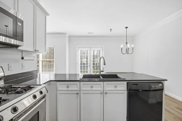 a bedroom with a large bed and a chandelier