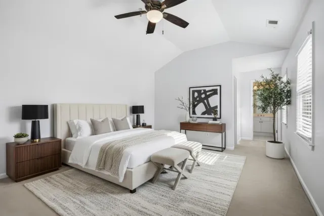 a bathroom with a bathtub shower sink vanity mirror and toilet
