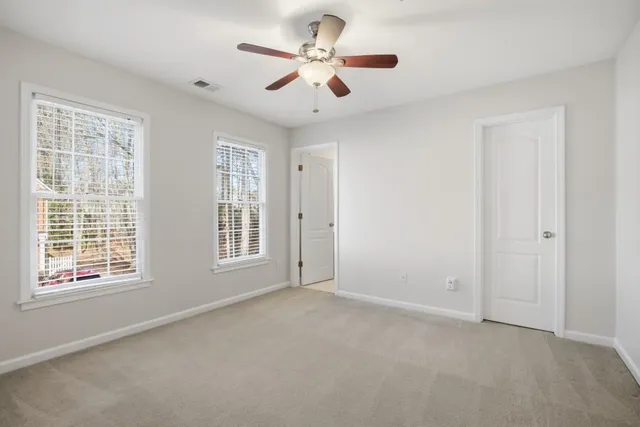 a view of a yard with large trees
