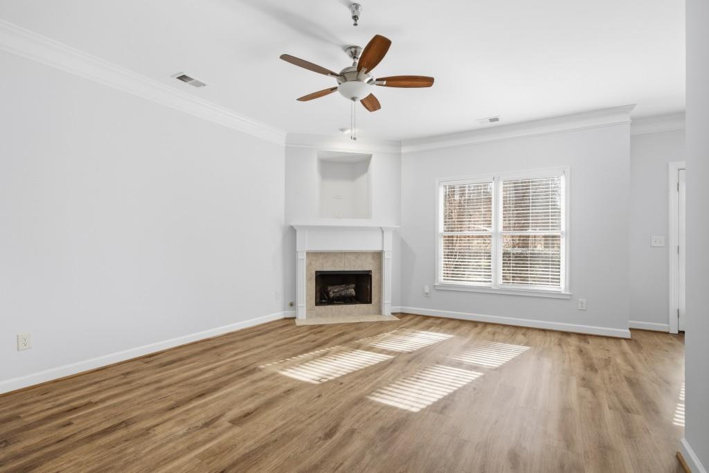 1287 Harris Commons Place Roswell, GA 30076 - Photo 2 of 25 a view of an empty room with wooden floor and a window