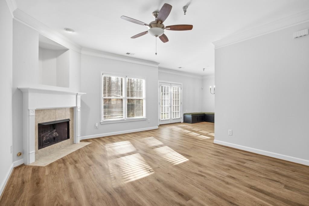 1287 Harris Commons Place Roswell, GA 30076 - Photo 4 of 25 a view of an empty room with a fireplace and a window