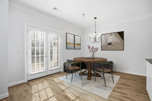 a view of a kitchen with wooden floor and staircase