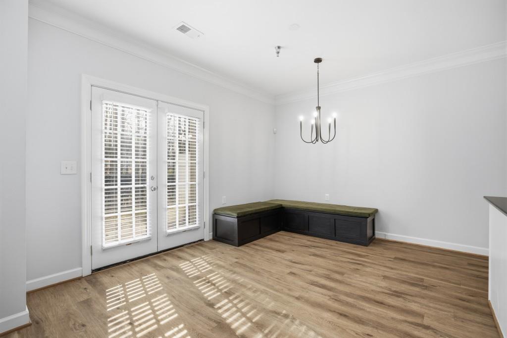 1287 Harris Commons Place Roswell, GA 30076 - Photo 7 of 25 a bedroom with a bed and wooden floor