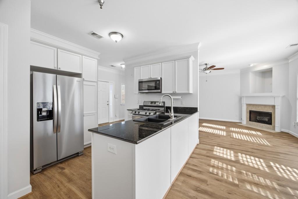 1287 Harris Commons Place Roswell, GA 30076 - Photo 8 of 25 a kitchen with granite countertop a refrigerator stove and sink