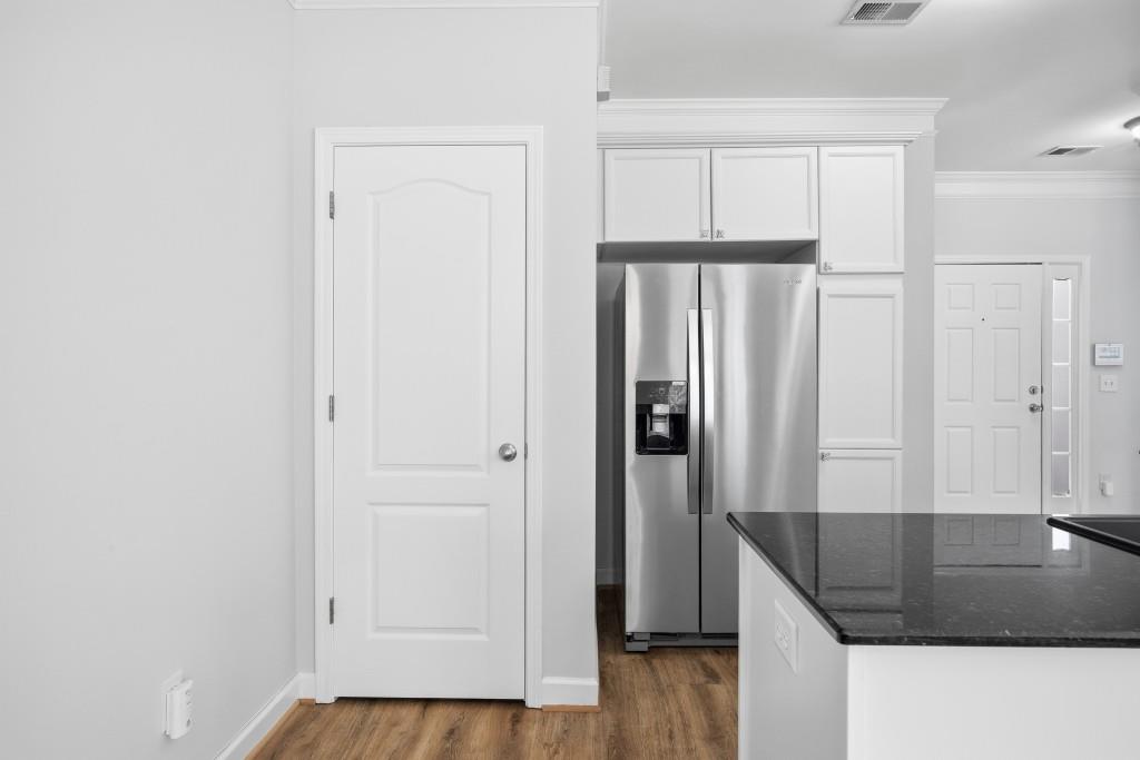 1287 Harris Commons Place Roswell, GA 30076 - Photo 9 of 25 a view of a kitchen with wooden floor and staircase
