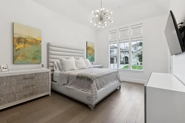 a bedroom with a large bed lamps and window