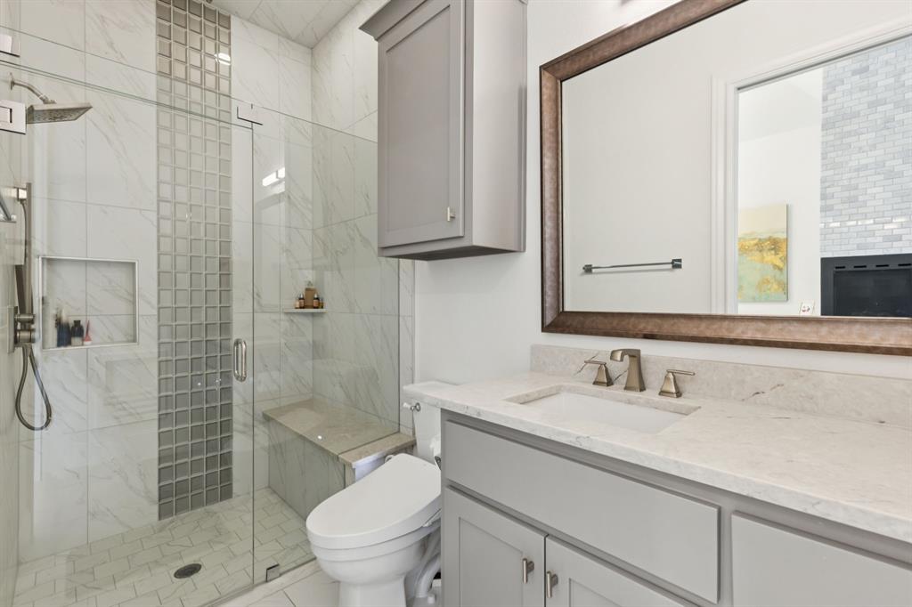 818 Brett Drive Allen, TX 75013 - Photo 15 of 28 a bathroom with a sink a toilet and shower