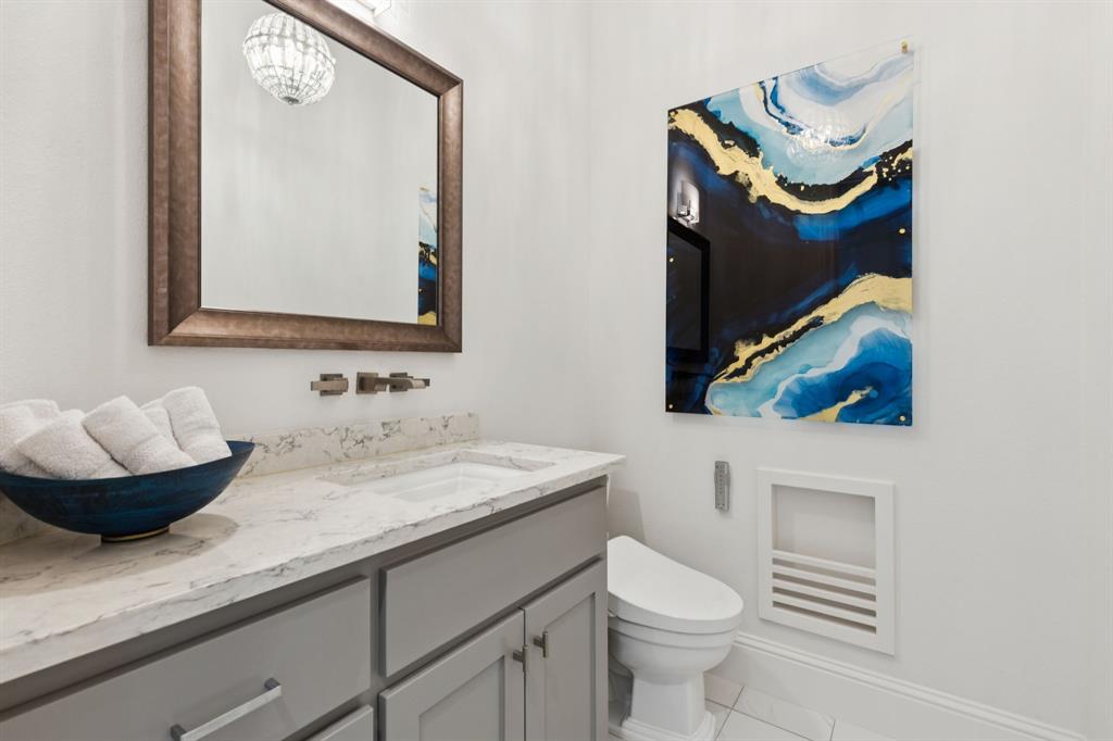 818 Brett Drive Allen, TX 75013 - Photo 16 of 28 a bathroom with a toilet sink and mirror