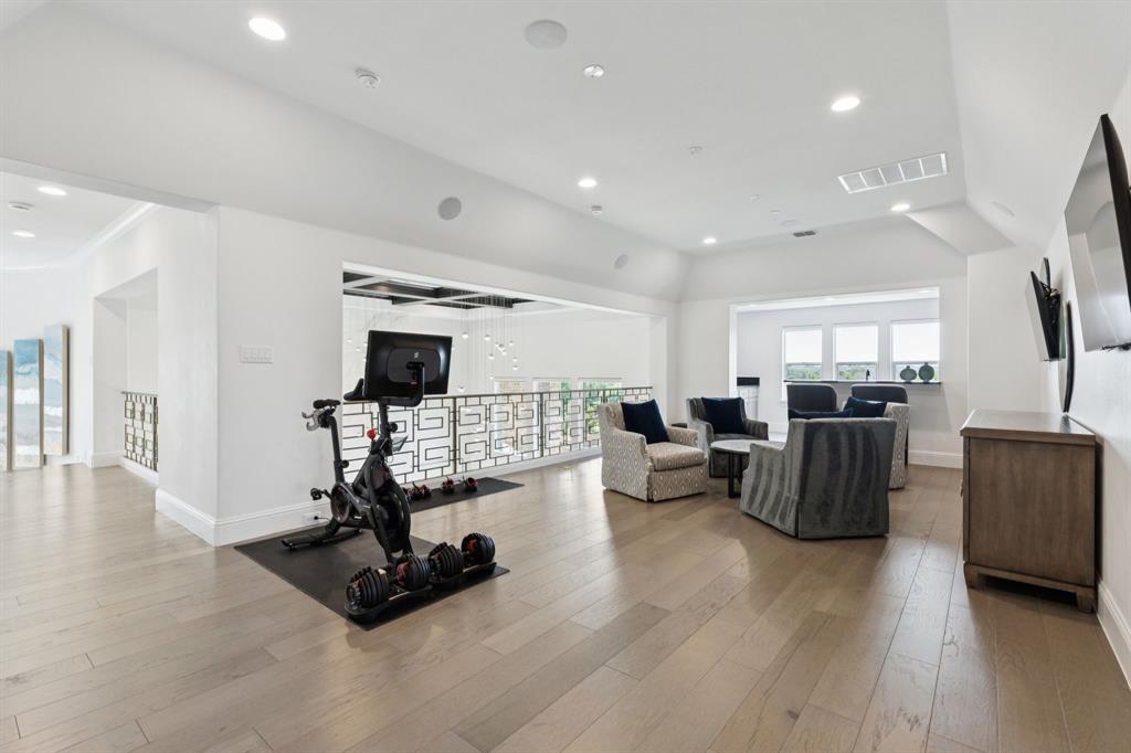 818 Brett Drive Allen, TX 75013 - Photo 18 of 28 a living room with furniture flat screen tv and a fireplace