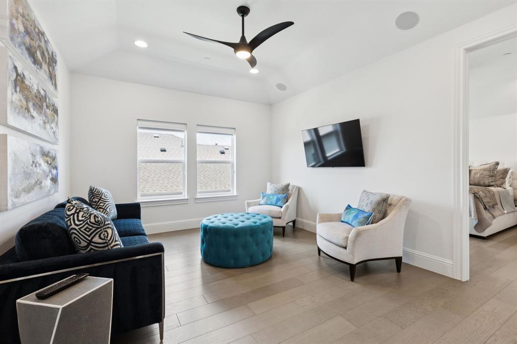 818 Brett Drive Allen, TX 75013 - Photo 20 of 28 a living room with furniture and a flat screen tv