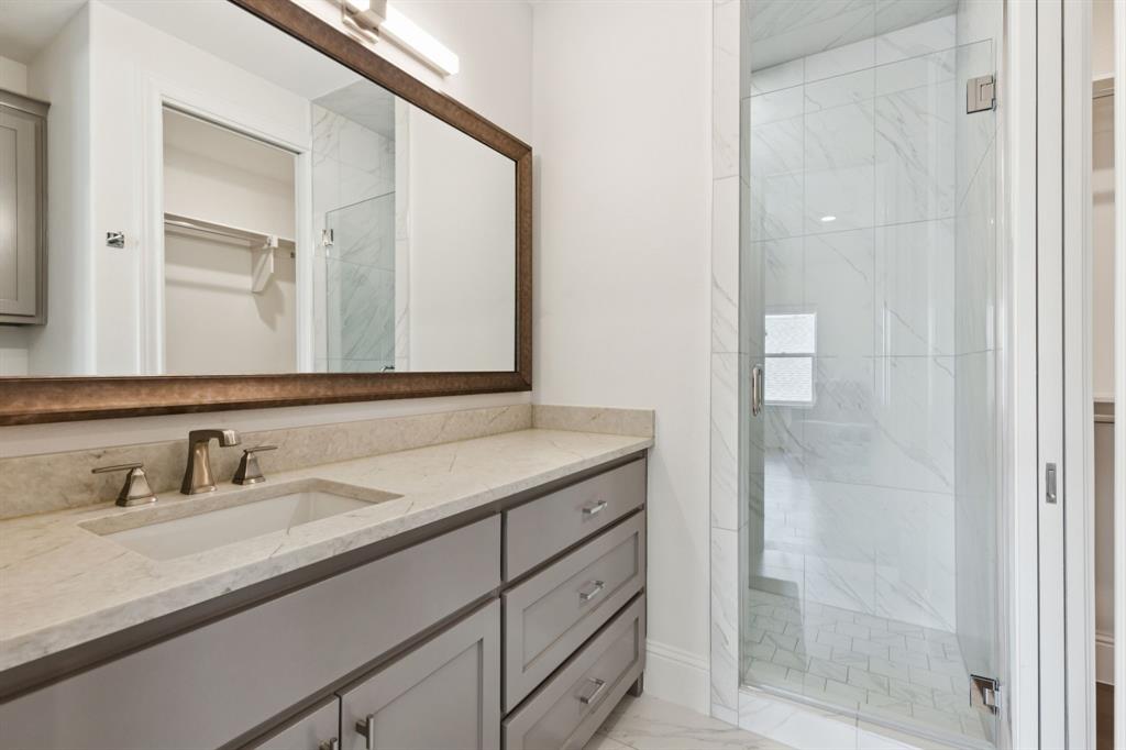 818 Brett Drive Allen, TX 75013 - Photo 22 of 28 a bathroom with a sink and a mirror