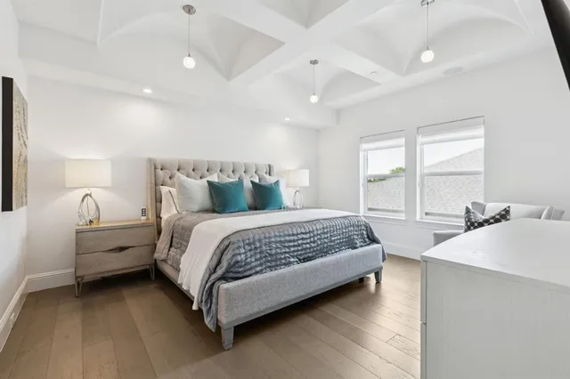 a spacious bedroom with a bed and a table