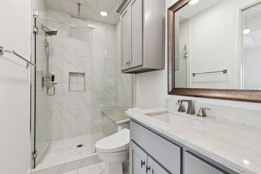 818 Brett Drive Allen, TX 75013 - Photo 24 of 28 a bathroom with a sink a toilet and shower