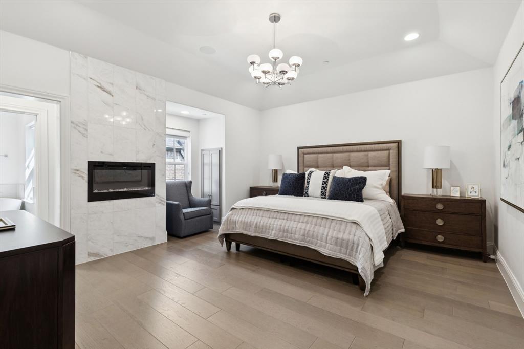 818 Brett Drive Allen, TX 75013 - Photo 25 of 28 a spacious bedroom with a bed and a television