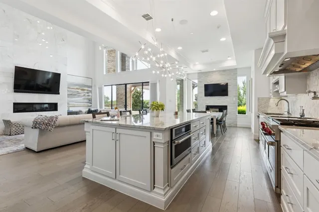 a kitchen with stainless steel appliances a white cabinets and a couch