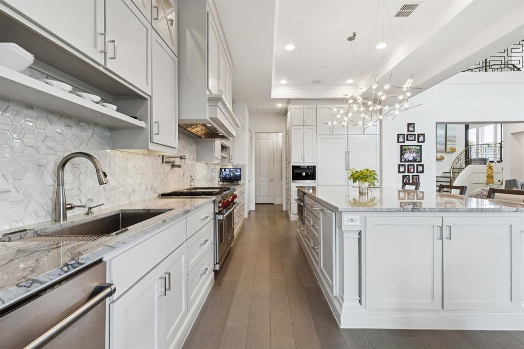818 Brett Drive Allen, TX 75013 - Photo 4 of 28 a kitchen with stainless steel appliances granite countertop lots of counter top space and cabinets