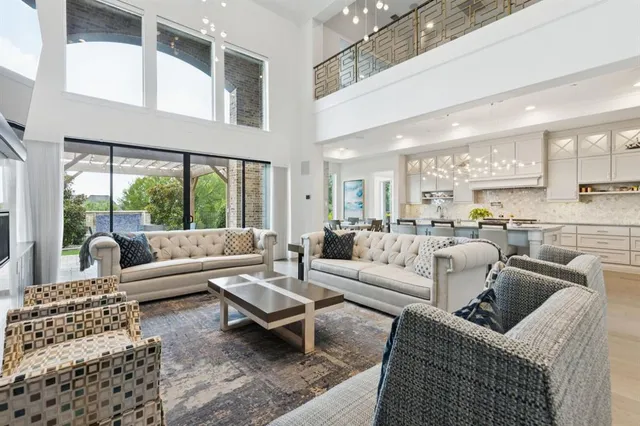 a living room with furniture wooden floor and a large window