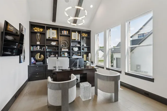a dining room with furniture and a floor to ceiling window