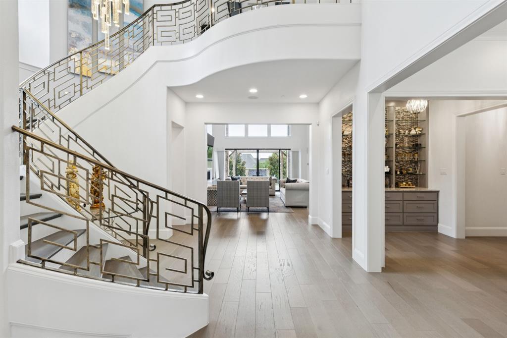 818 Brett Drive Allen, TX 75013 - Photo 9 of 28 a view of entryway and hall with wooden floor