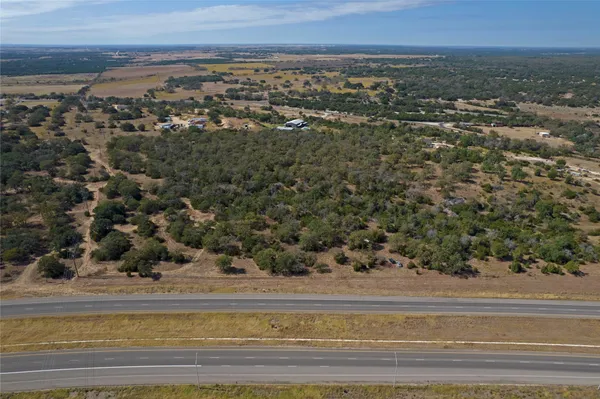 an aerial view of a houses with a yard
