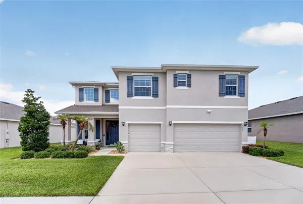 a front view of house with yard and green space