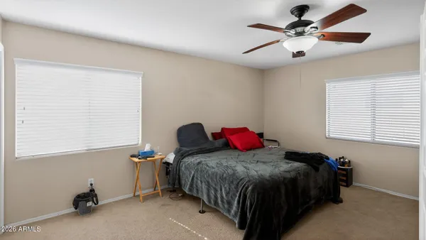 a bedroom with a bed closet and a window