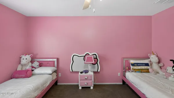 a bedroom with pink bed and pink cabinet