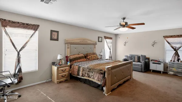 a bedroom with a bed a couch and a window