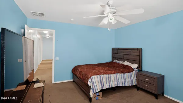 a bedroom with a bed and a chandelier
