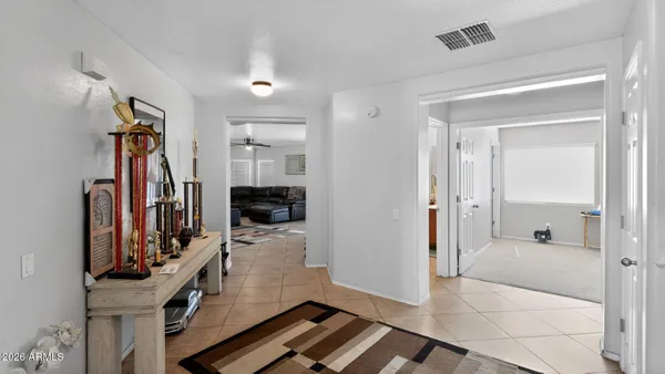 a view of a hallway with a livingroom and furniture