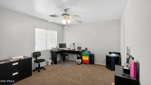 a view of a workspace with furniture and a window