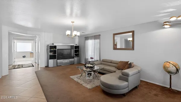 a living room with furniture and a chandelier