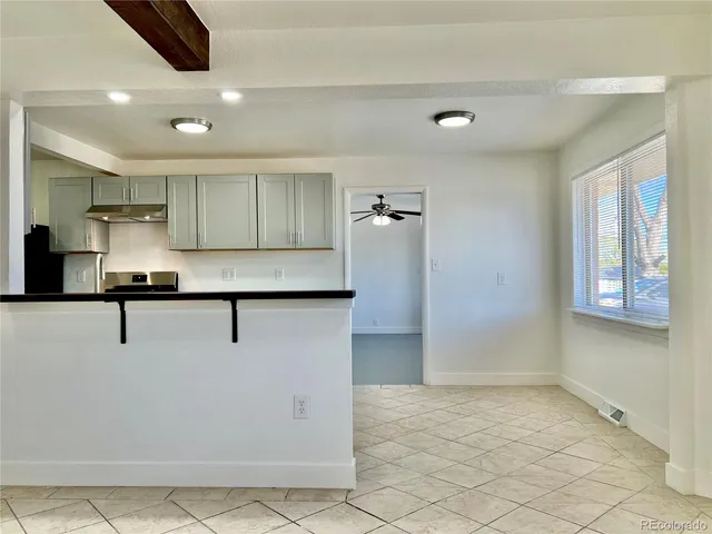 a view of kitchen with refrigerator and window