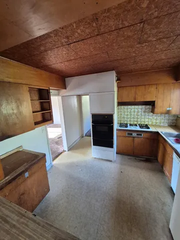 a kitchen with stainless steel appliances kitchen island granite countertop a sink and cabinets